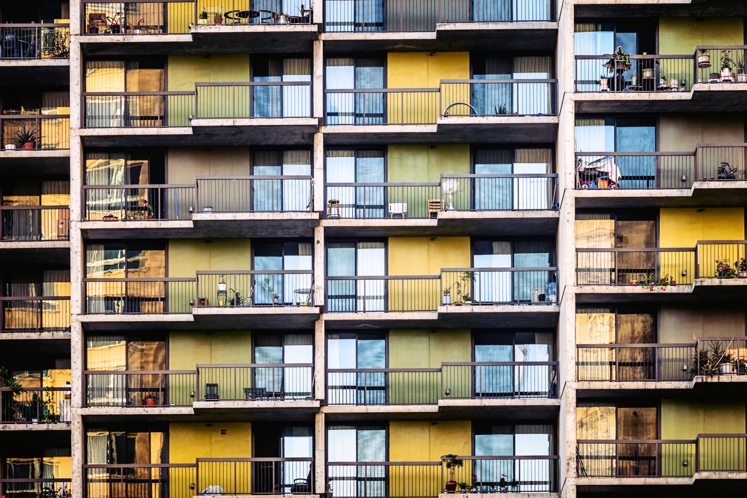 A figure on a balcony in soft morning light