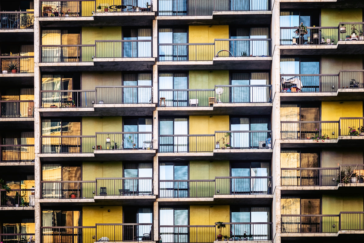A figure on a balcony in soft morning light